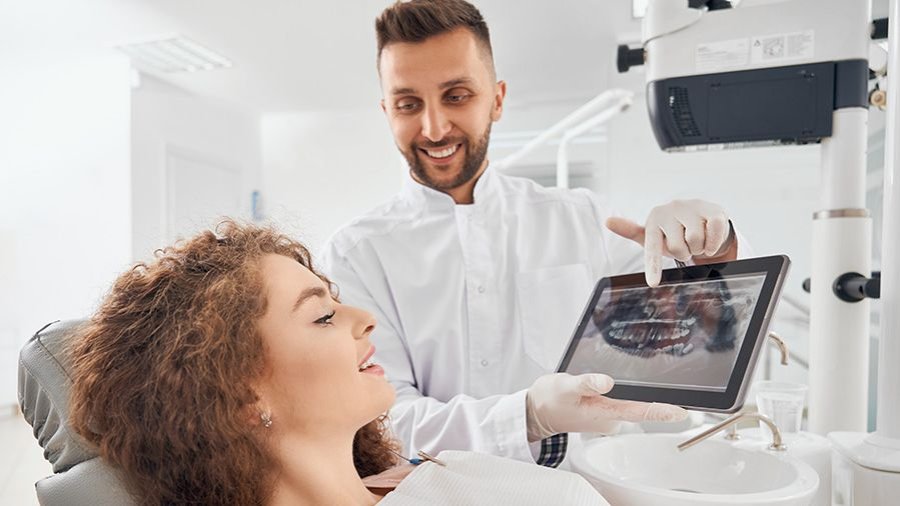 Doctor showing xray pictures teeth tablet